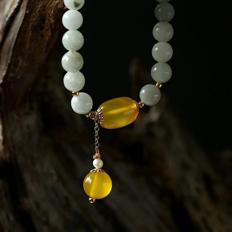 Women's bracelet with red agate round beads 7.5mm and hanging tassel in 14K gilded finish