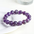 Natural feather amethyst crystal bracelet in Snow Mountain purple with scattered beads and Ruyi element.