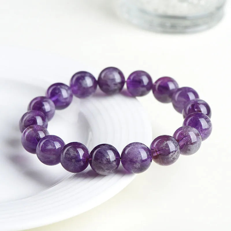 Natural feather amethyst crystal bracelet in Snow Mountain purple with scattered beads and Ruyi element.