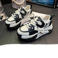 Leather sports casual shoes with thick sole and wedge heel, in black and white colour with front lace-up.