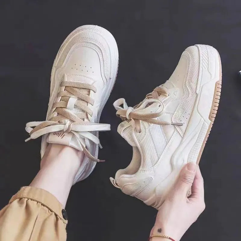 Beige and pink low-top sneaker with a height-increasing rubber sole on a white background