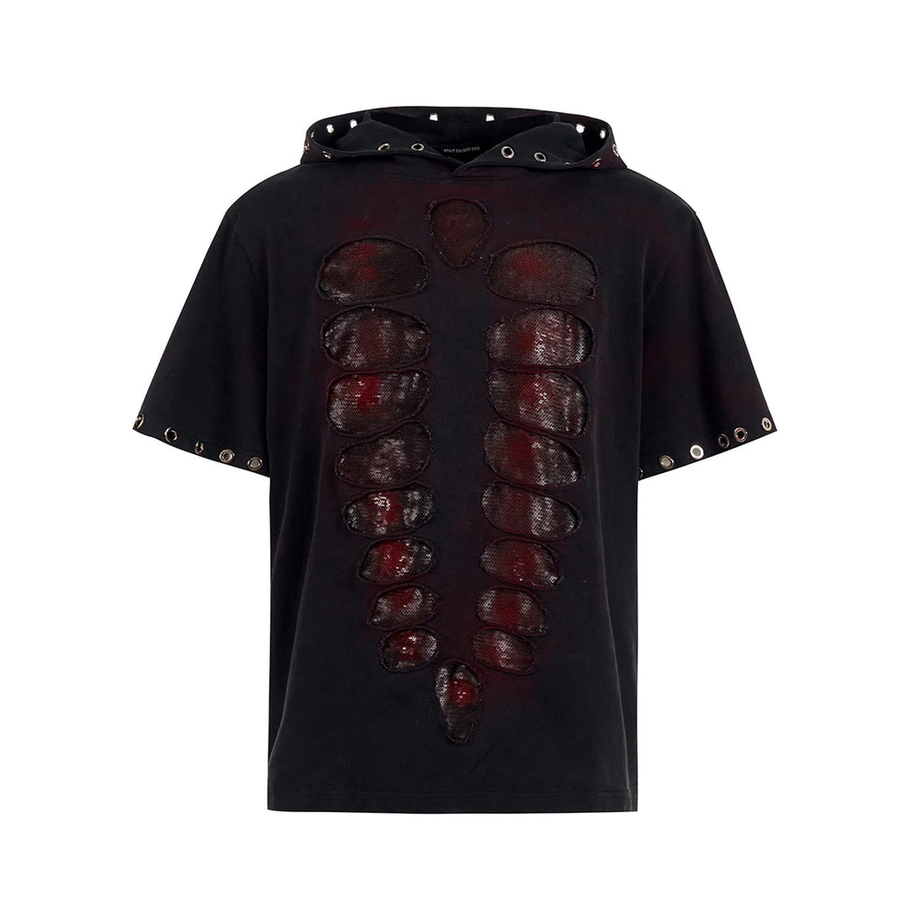 Black loose-fit men's hooded T-shirt covered in reflective sequins, shown in a casual setting.