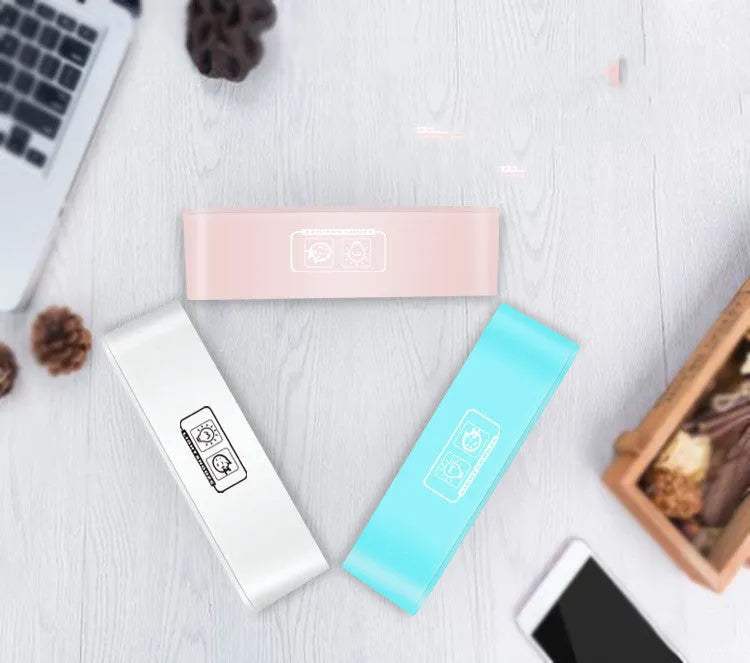Blue rectangular LED atmosphere light alarm clock with digital display on a wooden desk.