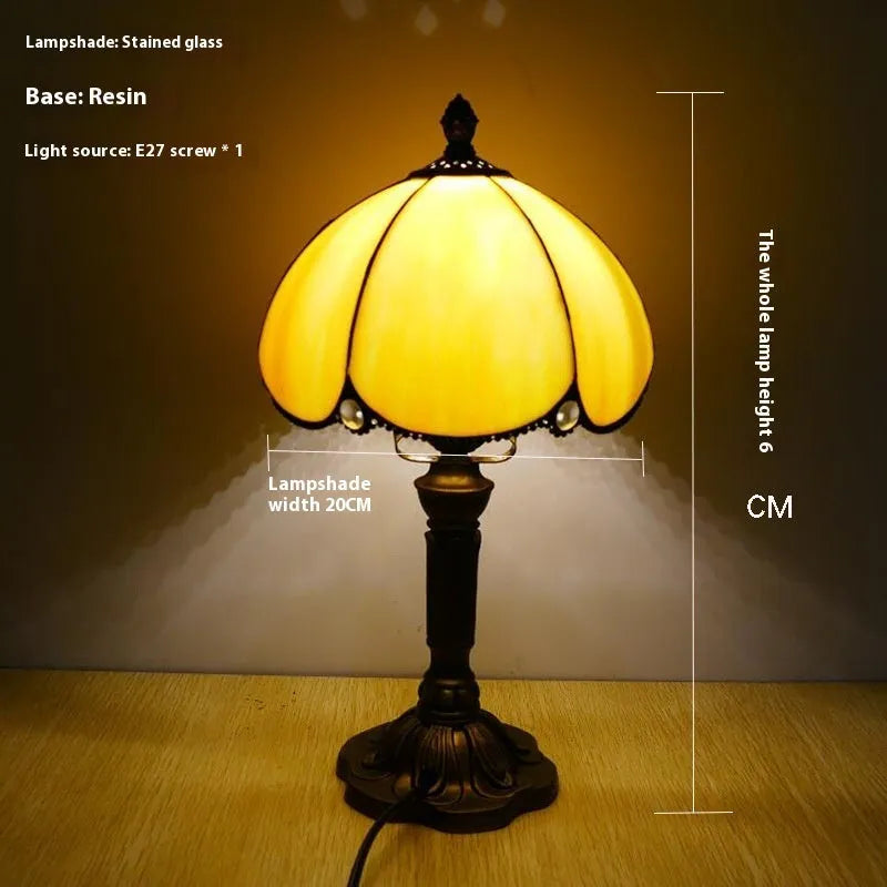 Beige simple modern creative art bedside lamp 20cm width on a bedside table