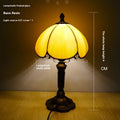 Beige simple modern creative art bedside lamp 20cm width on a bedside table