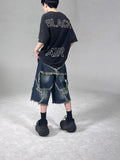 Blue denim shorts with five-pointed star embroidery and frayed edges, loose fit silhouette