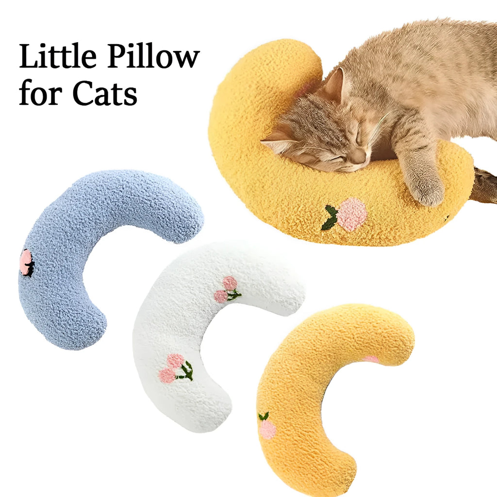 Small half-donut shaped pet pillow in blue faux fur, showing quilted texture and plush filling.
