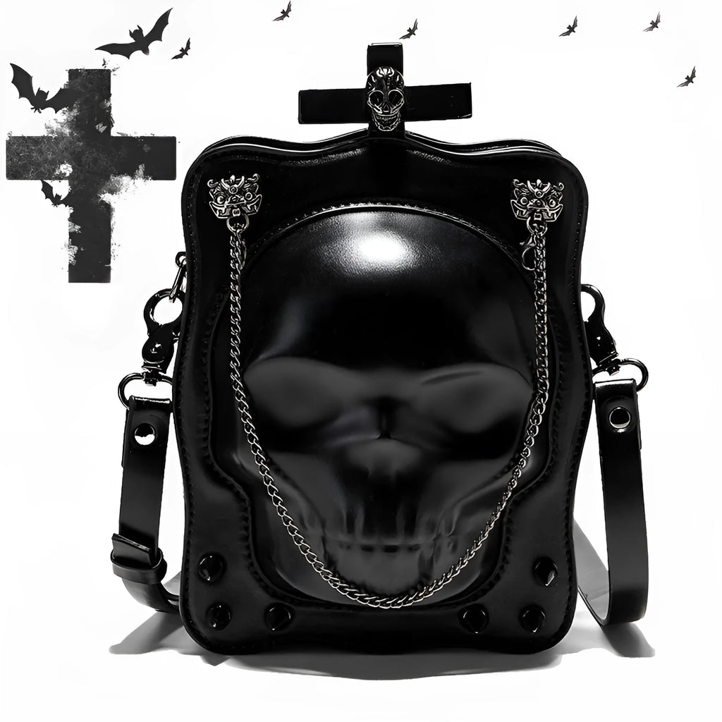 Black mini square crossbody bag with embossed skull design, chain accents, and zipper closure