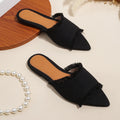 Women's denim slipper with tassel detail in apricot colour, showing flat profile and leather interior.