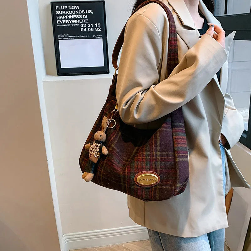 Large capacity soft woolen shoulder bag for women in khaki with pendant, horizontal square shape with sewing line detail.