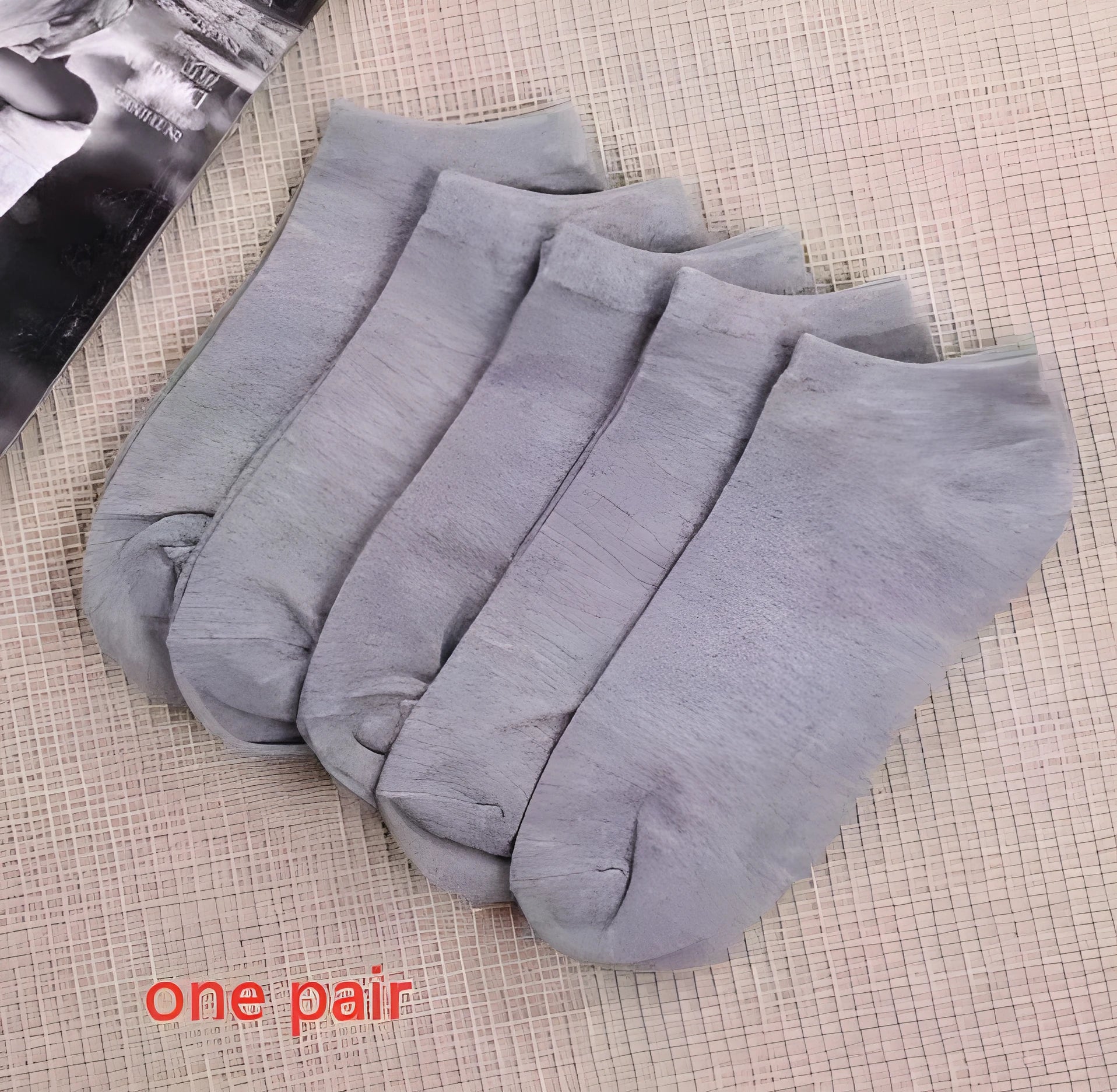 Black, white, and grey boat socks and medium tube socks from Degner in cotton blend fabric