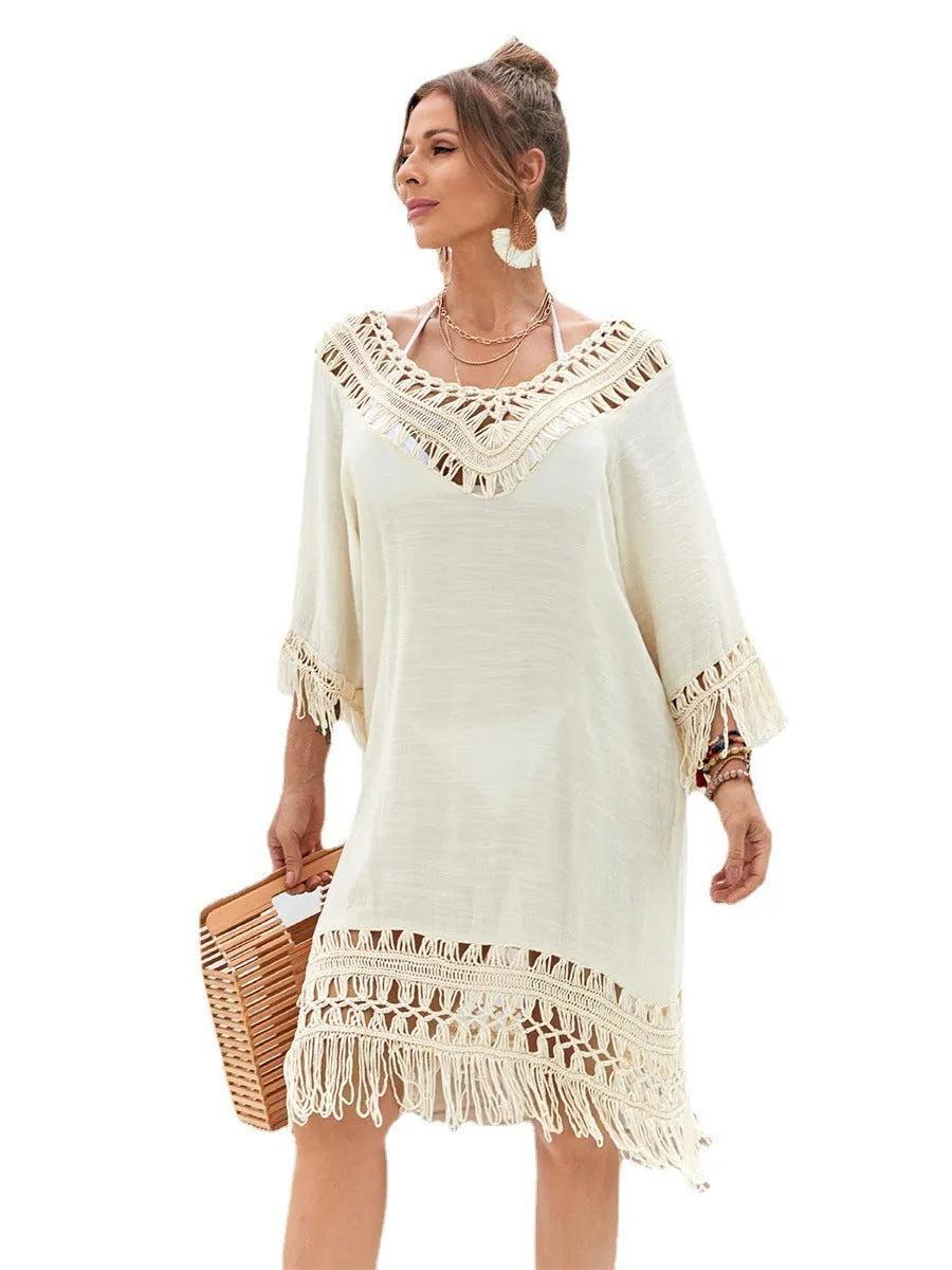 Apricot coloured hand-crocheted women's beach dress on a hanger