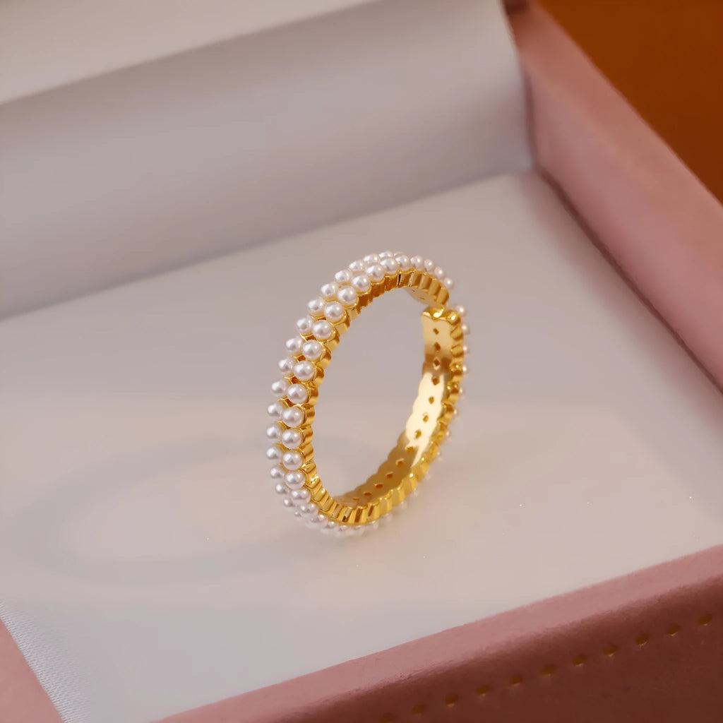 Gold geometric open mouth ring with pearl detail on female hand