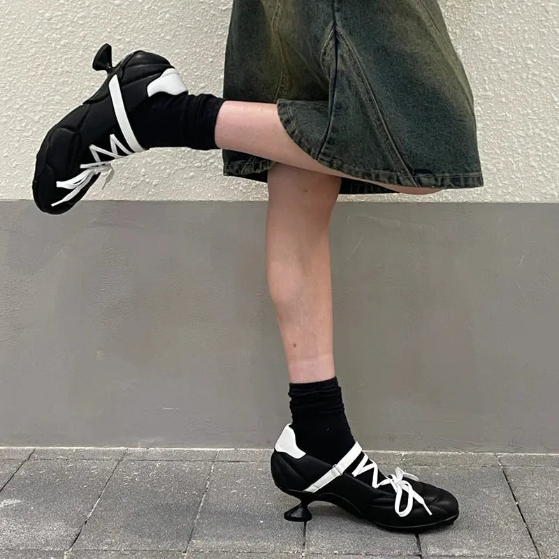 Women's silver lace-up sports shoes with a bow on the front, round toe, and leather stitching details on the microfiber upper.
