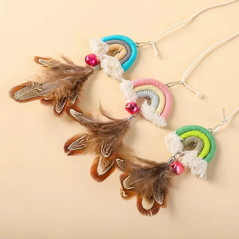 Blue feather rope cat toy with elastic cord hanging from door with sticky buckle clamp