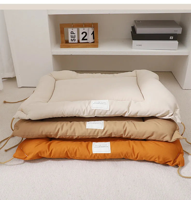 Tied cage cushion for dogs and cats in beige, showing platform attached to wire crate bars – size L.