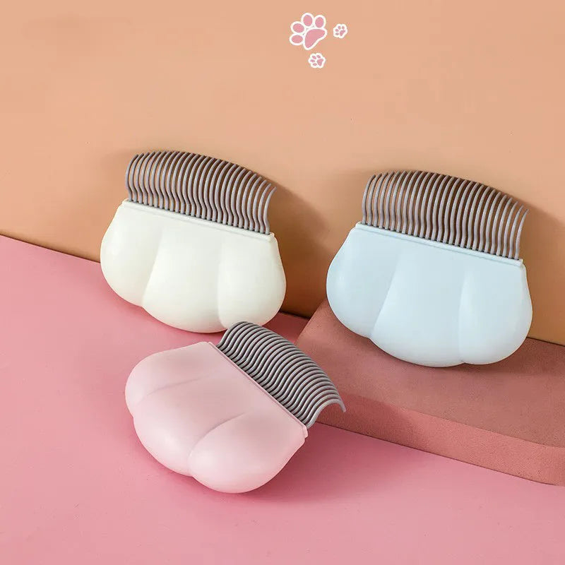 Paw Soft deshedding grooming brush for cats and dogs on a white background.