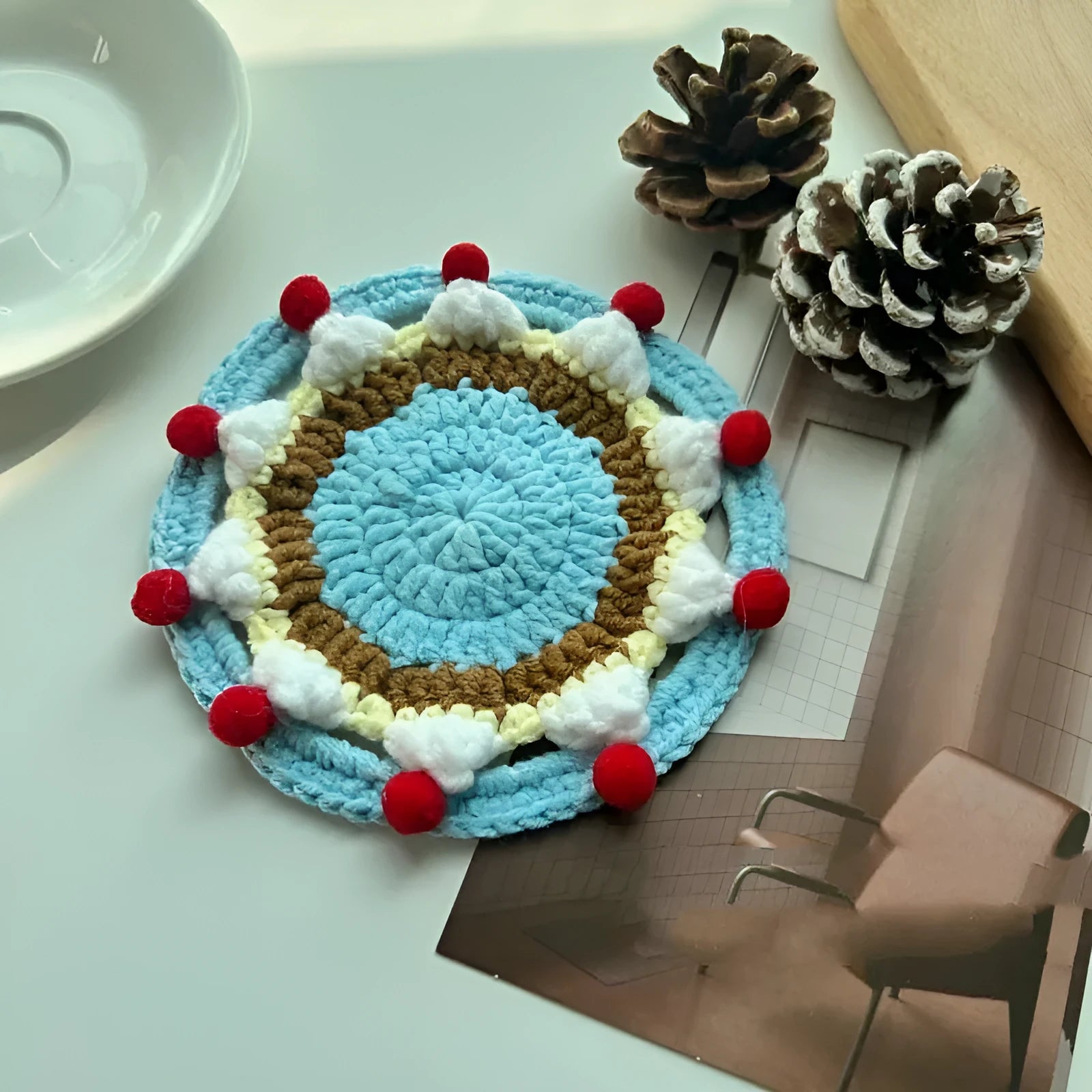 Round wool cake coaster 9cm diameter on a wooden table