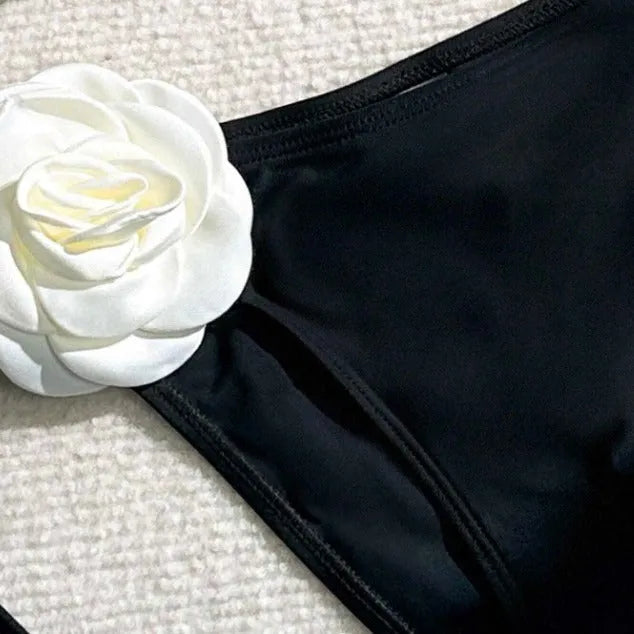 Black 3D flower lace drawstring bikini swimsuit with backless top and shorts on a model