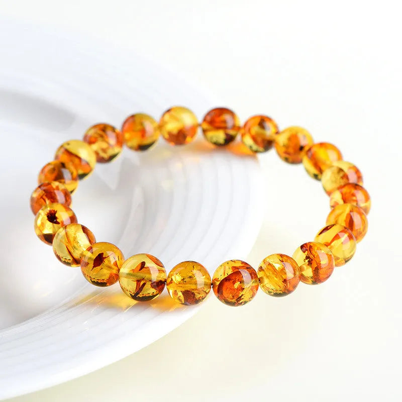 Natural yellow piebald amber bracelet with geometric beads and polished finish