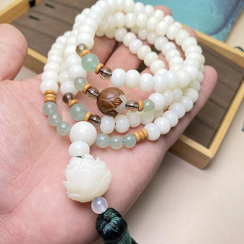 White Jade Bodhi 108 bead bracelet showing detail of spherical beads on a wrist.