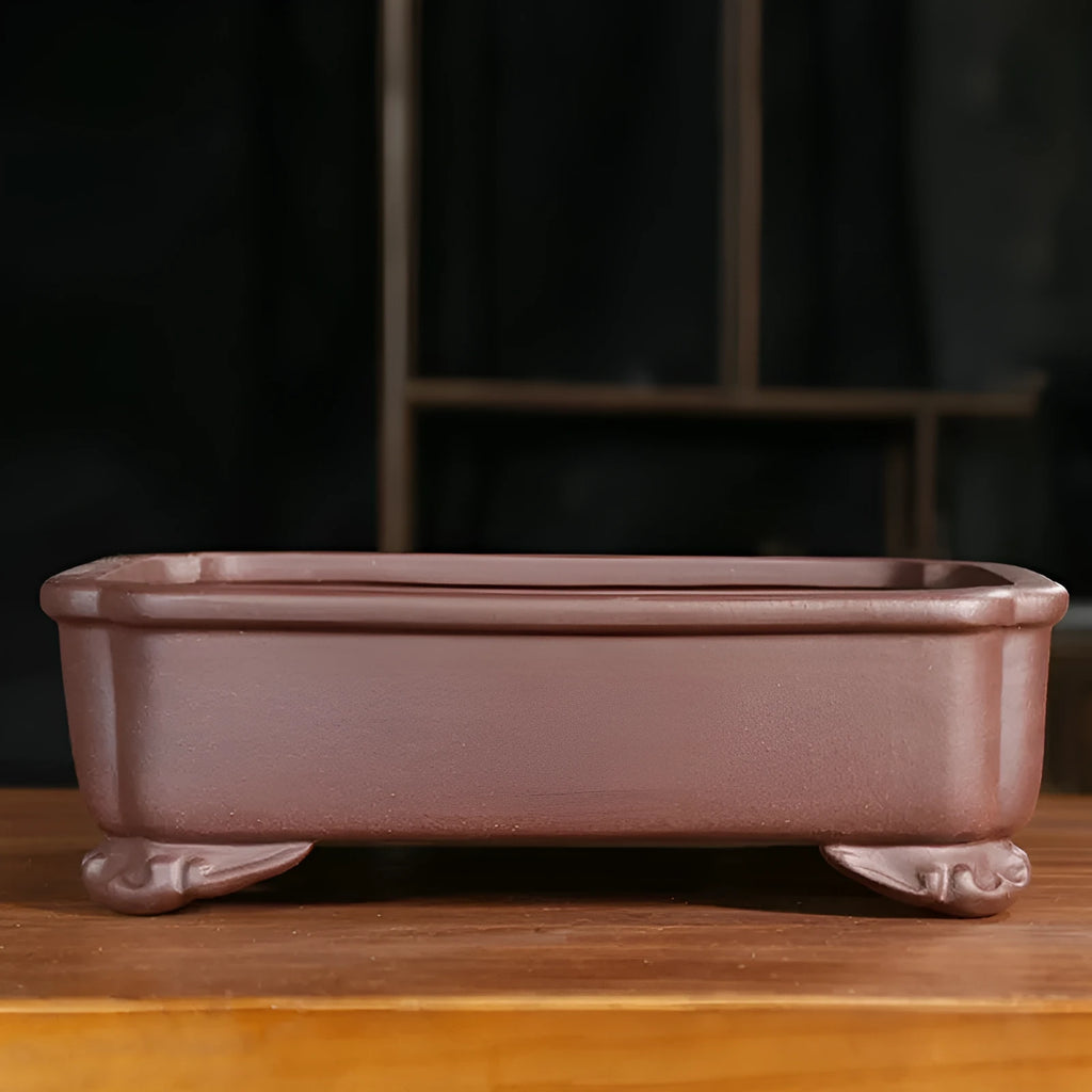 Rectangular antique purple sand bonsai pot on floor, showing Old Segment Mud textured finish.