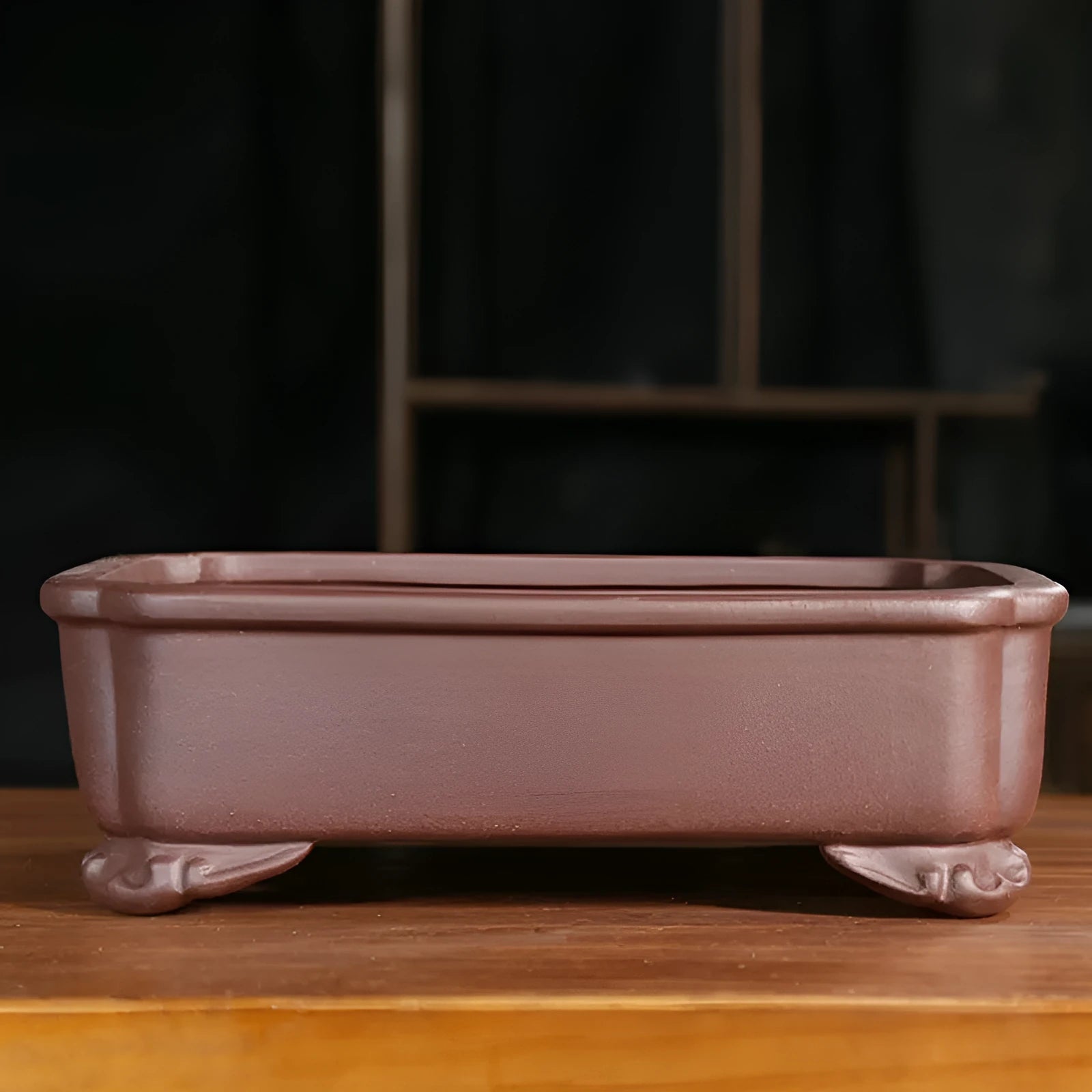 Rectangular antique purple sand bonsai pot on floor, showing Old Segment Mud textured finish.