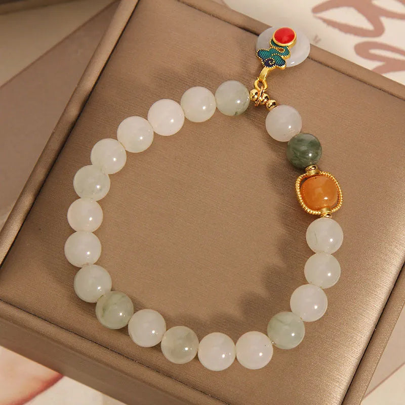 Ice jade colour women's bracelet with xiangyun buckle and pearl details.