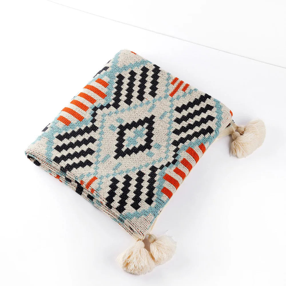 Bohemian style acrylic sofa throw blanket with tassel trim in a geometric pattern colour