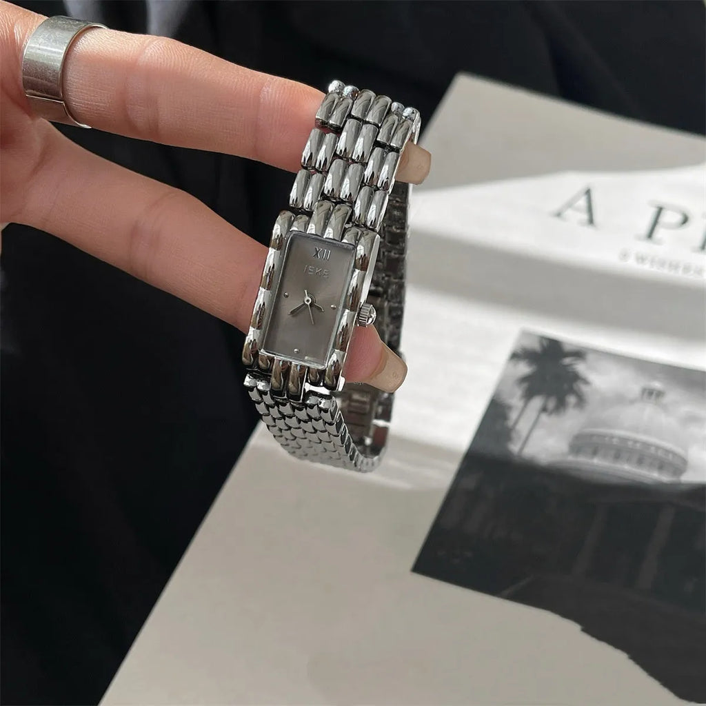 Women's stainless steel bracelet watch with 15mm dial, showing gold strap and white face option.