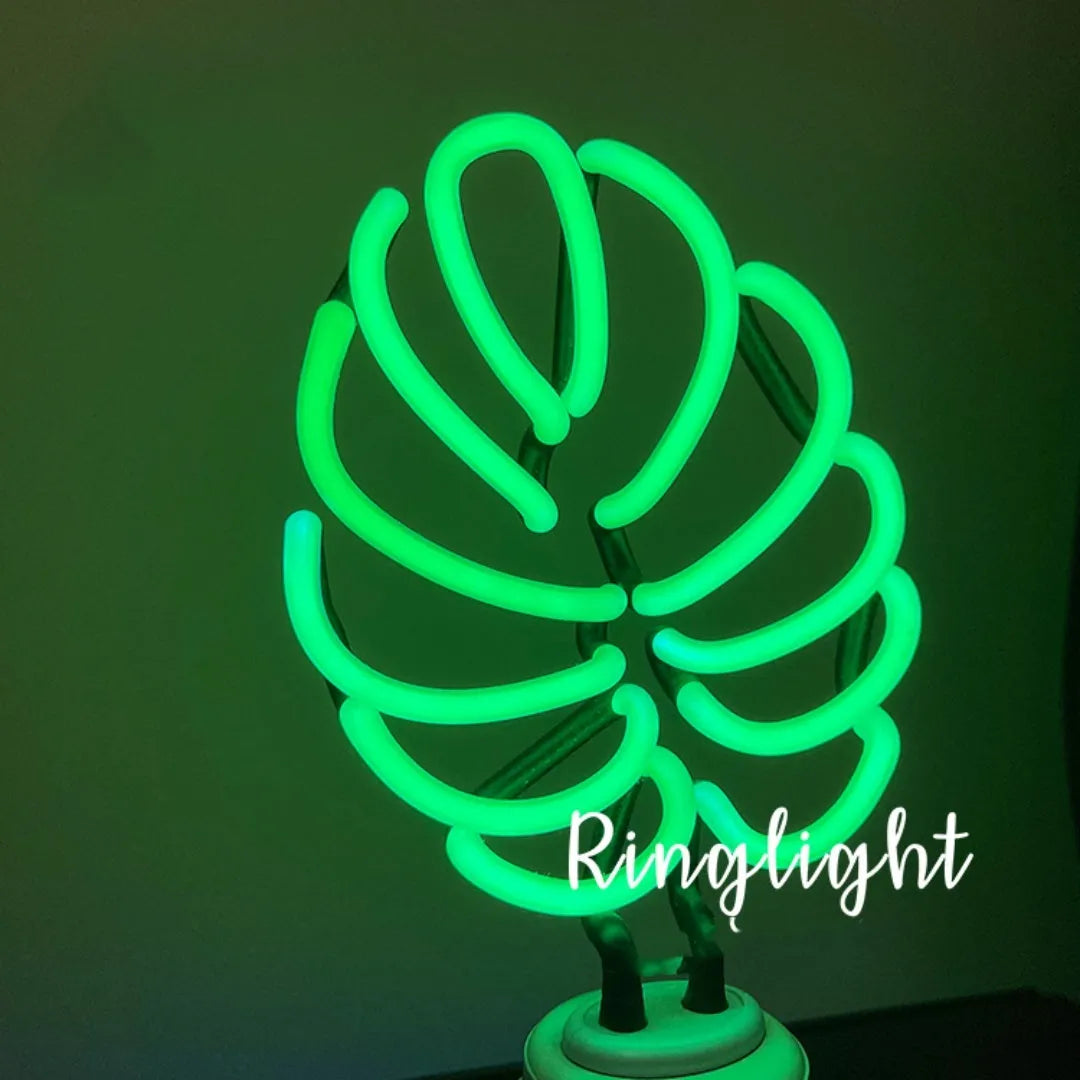 White tube bamboo shape desktop lamp emitting green light, with USB cable.