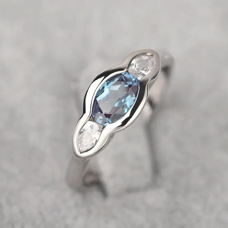 Women's geometric ellipse ring in white gold tone with inlaid zircon detailing, showing contemporary design