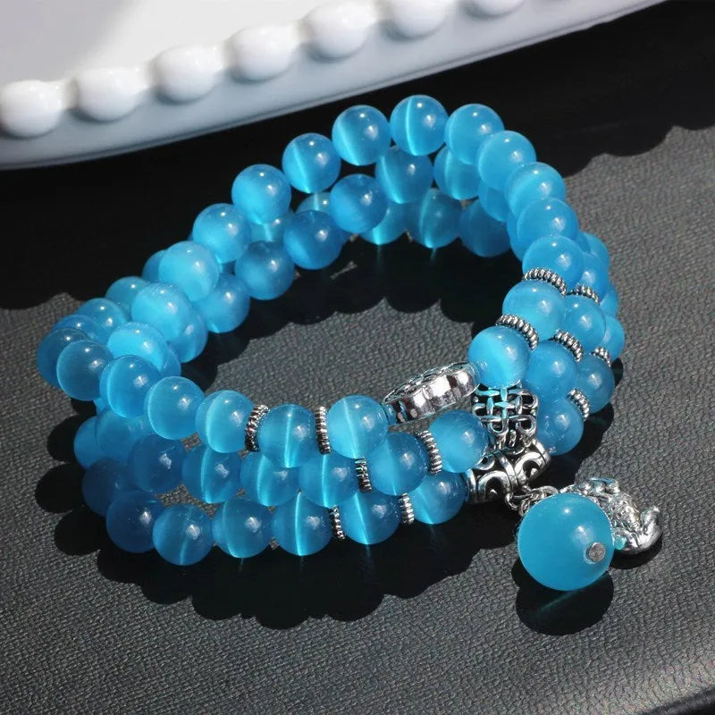 Crystal opal bracelet with 8mm cat eye bead and lucky cat charm in three-ring wrap design