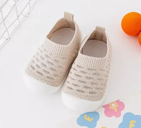 Baby soft sole non-slip walking shoes in cream yellow with fly woven cotton upper and natural rubber sole