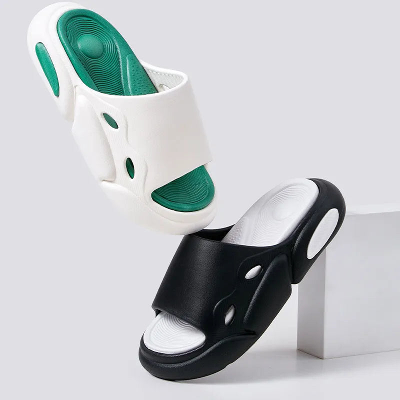 Two-colour couple slippers showing thick EVA sole and round toe, displayed in black and white colourway.