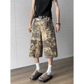 Yellow jeans with snake pattern camouflage design in cropped length