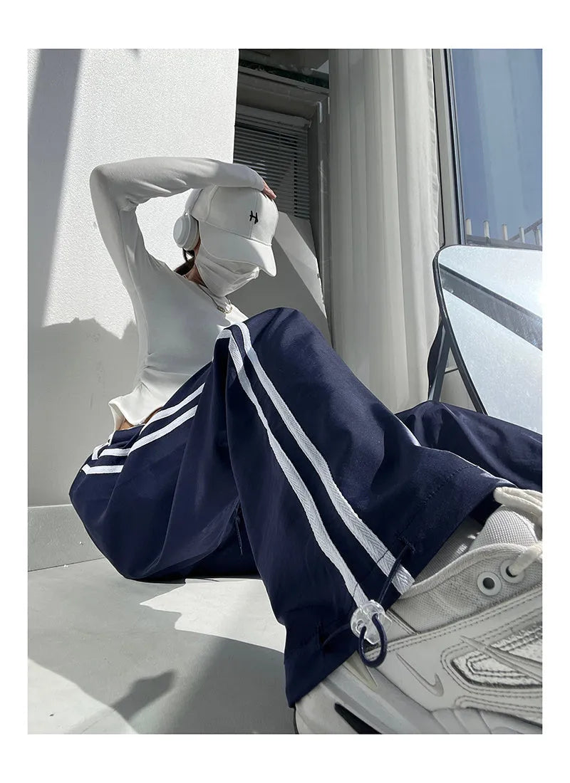 Women's navy blue parallel bars contrast colour loose straight leg trousers on a low waist.
