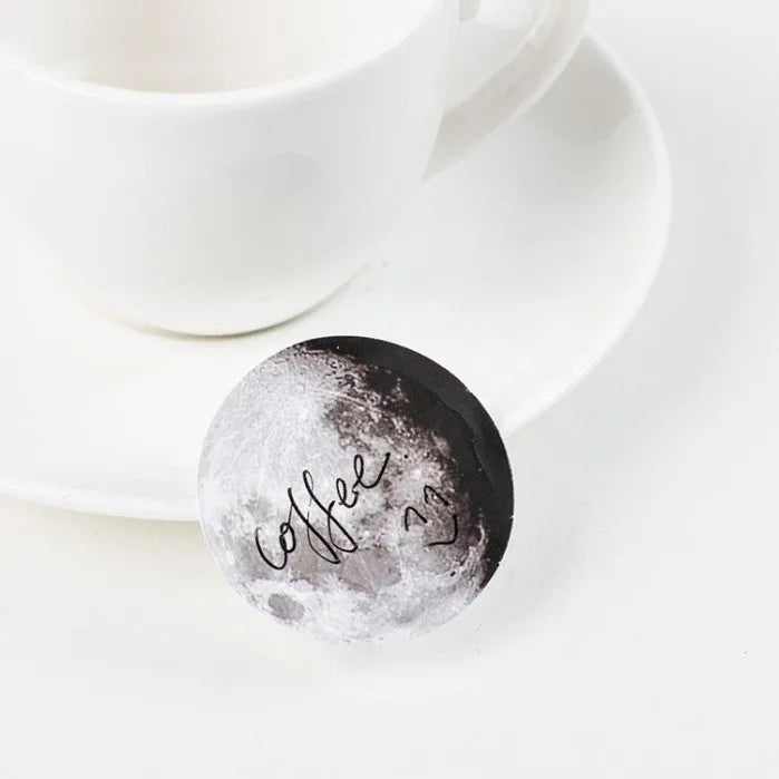 Boxed stickers showing moon phases and calendar planet designs in black on self-adhesive paper, 45 pieces per pack