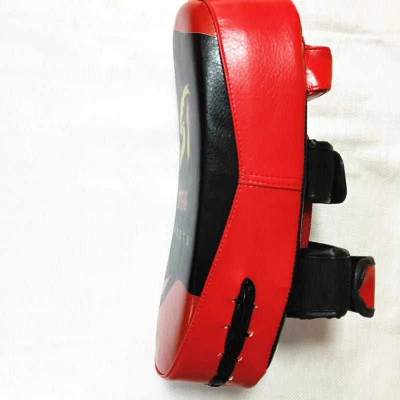 Black and red square hand-held martial arts foot target pad with buckle straps.