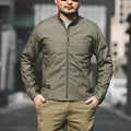 Men's brown tactical outdoor coat with multiple pockets and a plaid pattern