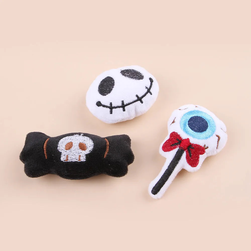 Small plush cat teaser wand with replaceable candy and skull head designs for interactive feline play