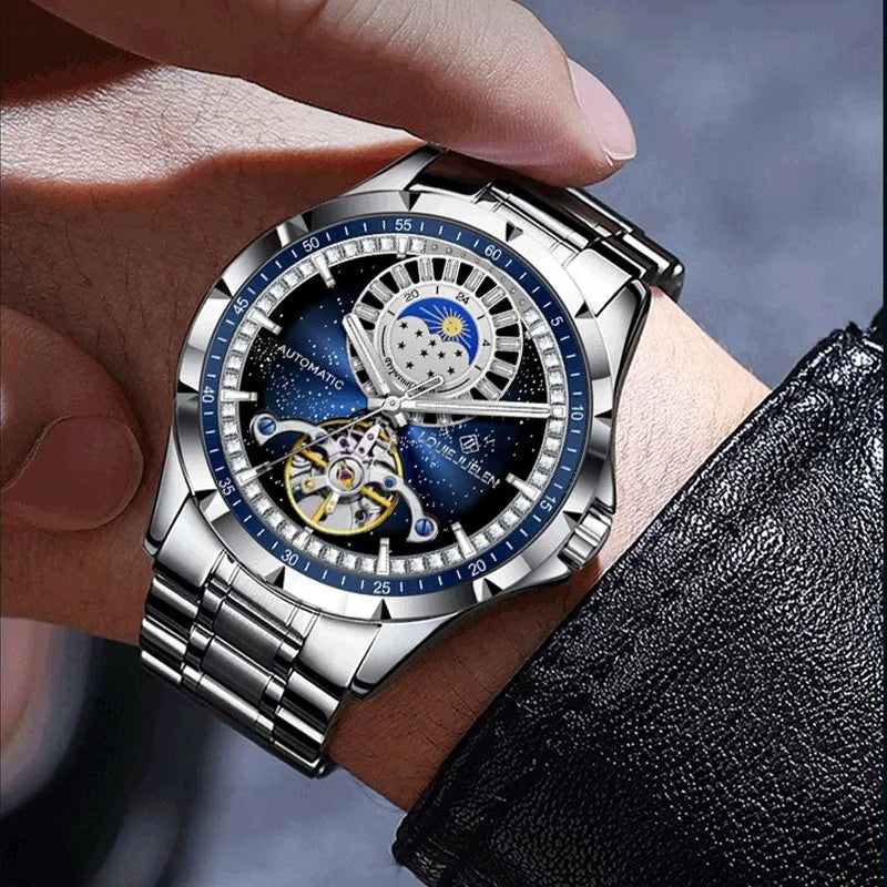Men's silver automatic mechanical watch with blue dial and stainless steel bracelet on wrist