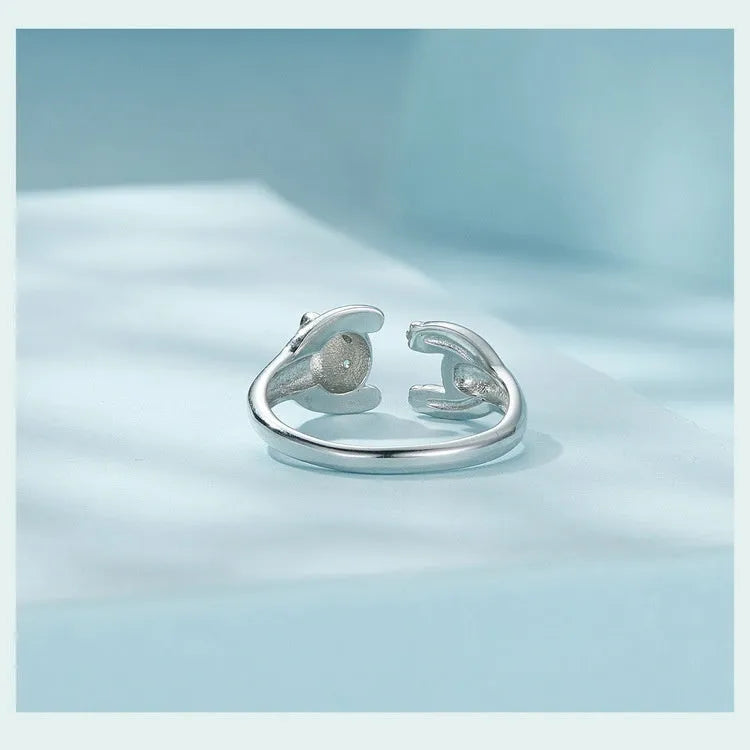 Adjustable sterling silver panda ring bracelet with white gold plating on a wrist.
