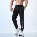 Men's black casual sweatpants with ankle tie closures and mid-waist design