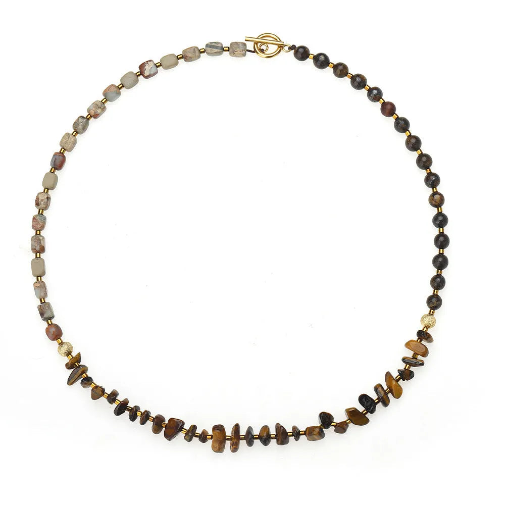 Tigereye Gravel Bronze Glow Ball Bracelet on brown background, handmade geometric texture