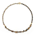 Tigereye Gravel Bronze Glow Ball Bracelet on brown background, handmade geometric texture