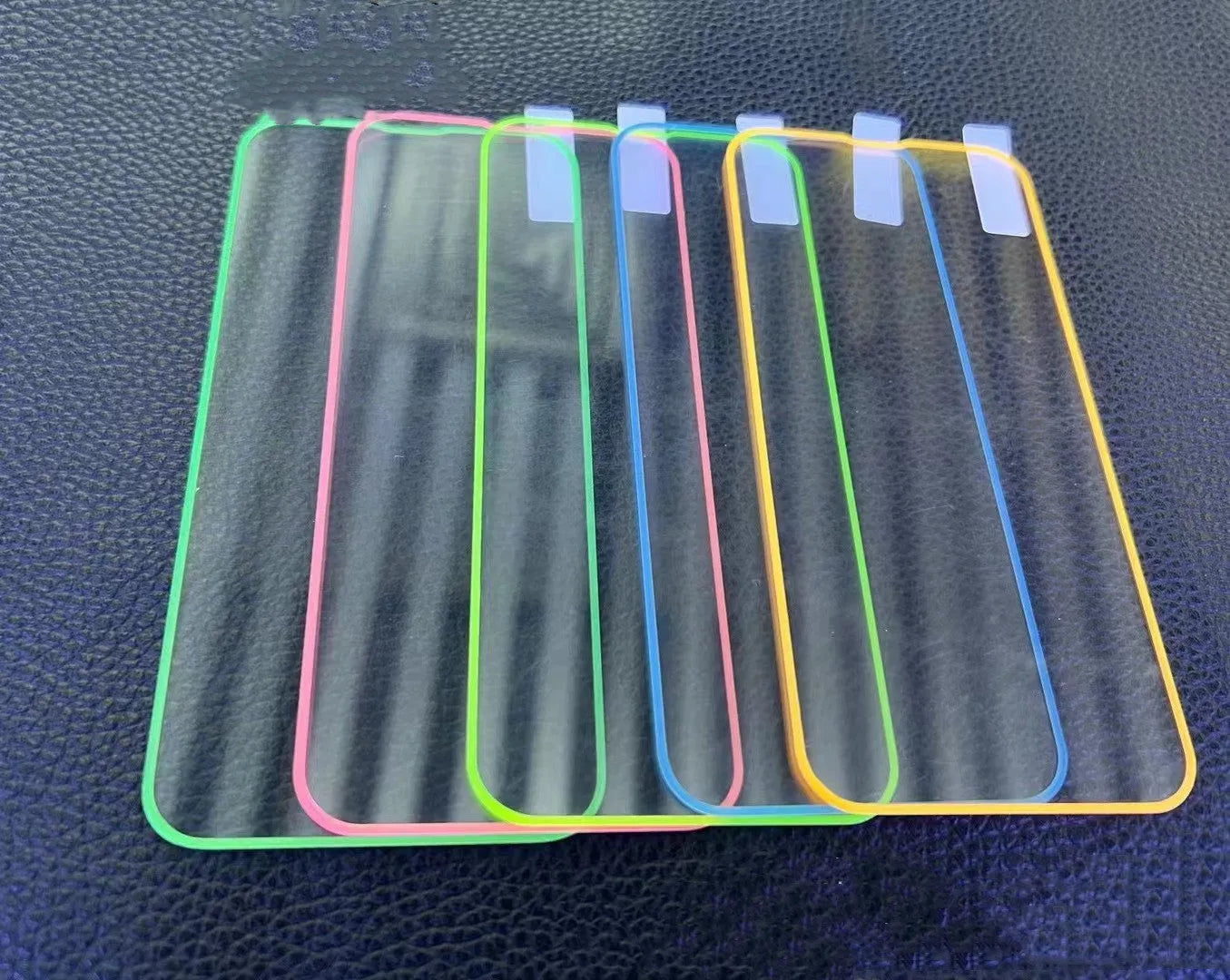 Fluorescent tempered glass screen protector for iPhone showing pink yellow green blue grass green colour options