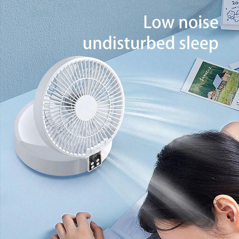 White portable folding fan with night light on a table, remote control beside it, showing its compact size.