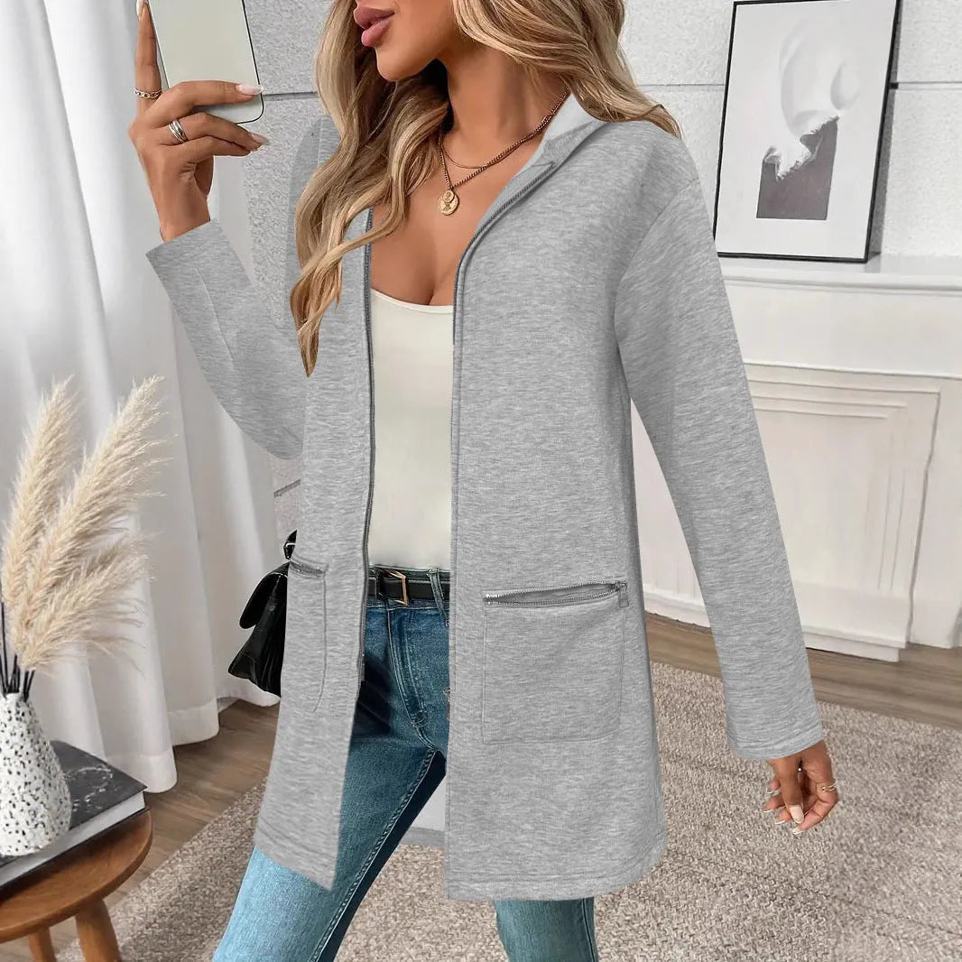 Women's loose casual mid-length cardigan coat in black with side pockets on a model