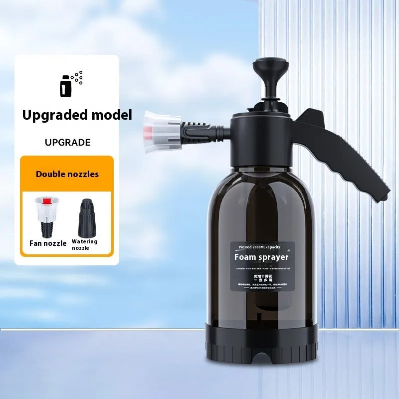 Black 2L foam watering can sprayer with handle and two nozzle attachments on a white background